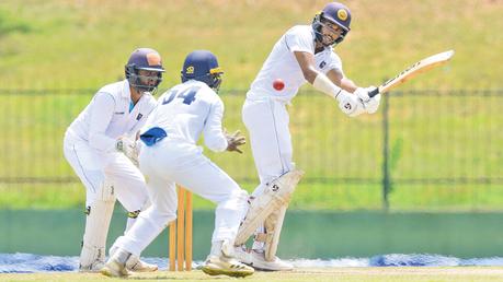 Jaffna  opener Navod Paranavithnaha  who scored  an unbeaten 59 playing a stroke while Colombo wicket keeper Sithra Gimhan looks on. (Pic courtesy SLC)