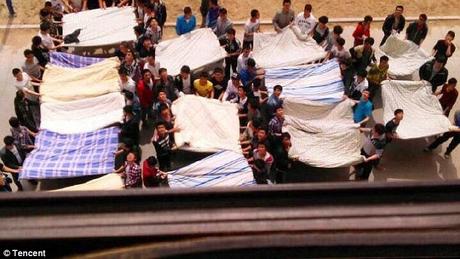 Chinese students attempt to save female from jumping to death ! bedsheets !!