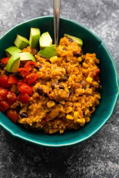 instant pot enchilada rice in bowl with avocados and tomatoes