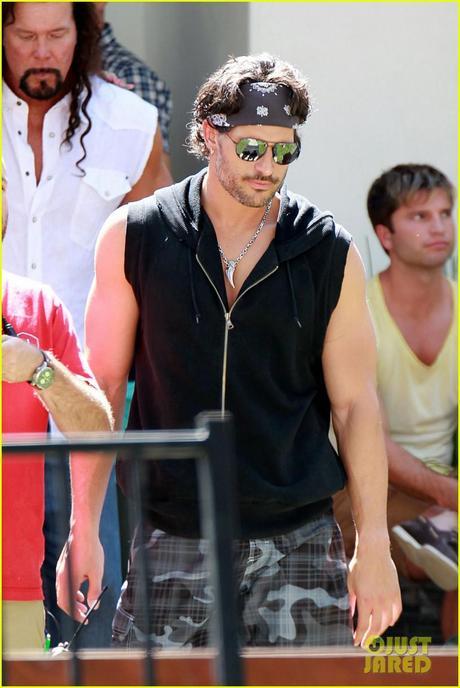 Muscle man Joe Manganiello, wearing a black sleeveless sweater and a bandana, finishes a scene on the set of the upcoming stripper film Joe Manganiello looks strippery on Magic Mike set