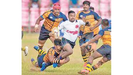 A Kandy SC player makes a break in the League rugby match against the Army SC.