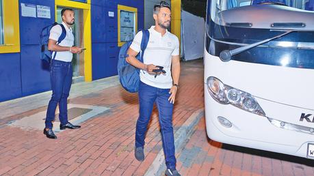 Oshada Fernando and Dhananjaya de Silva about to board the team bus.