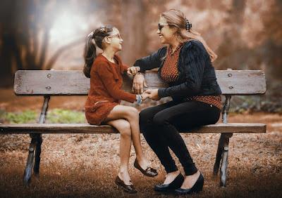 mother and daughter on a park bench