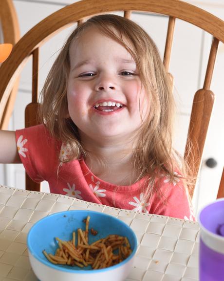 toddler girl eating spaghetti