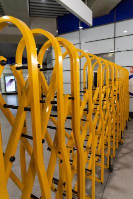 Photograph showing a yellow concertina barrier across the entrance to the Crossrail platforms inside the station
