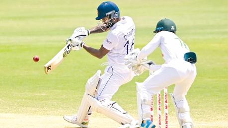 Dimuth Karunaratne plays a shot off the back foot.