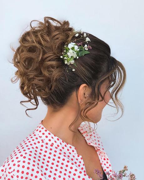 spring wedding hairstyles high curly bun with flowers jeanclaudeelmoughayar