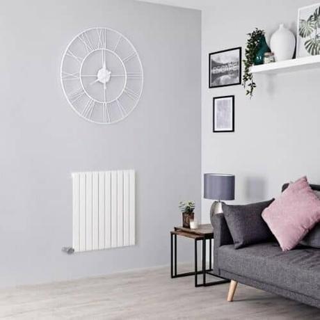milano capri wall mounted electric heater in a gray living room