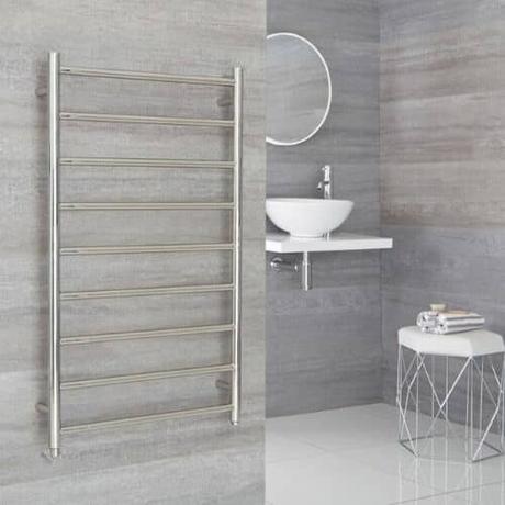 milano esk electric wall mounted heated towel rail on a gray wall
