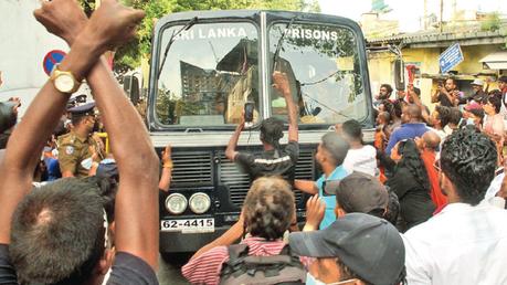 Protesters blocking the Prison bus yesterday.  Picture by Ruwan de Silva 