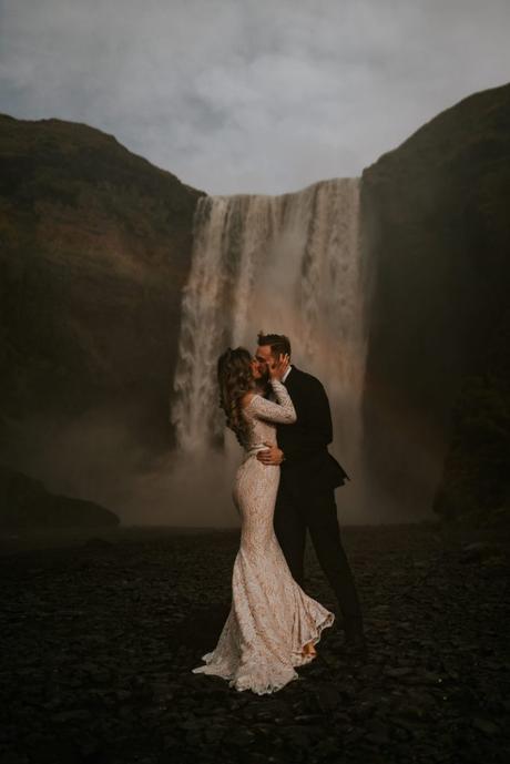 Married couple photographed with an Icelandic waterfal