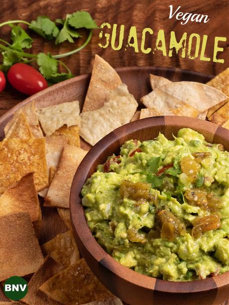 overhead photo of a platter o tortilla chips and a bowl of vegan guacamole
