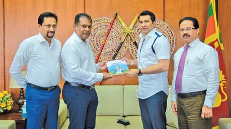 SLC President Shammi Silva handing over the SLC annual report to Sports Minister Roshan Ranasinghe. Sports Ministry Secretary Anuradha Wijekoon and SLC Exco member Sujeewa Godaliyadda are also in the picture. (Pic by Sports Ministry Media)