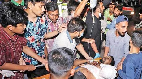 Rescue workers carry an injured victim to a hospital after a fire broke out at a container storage facility in Chittagong yesterday.