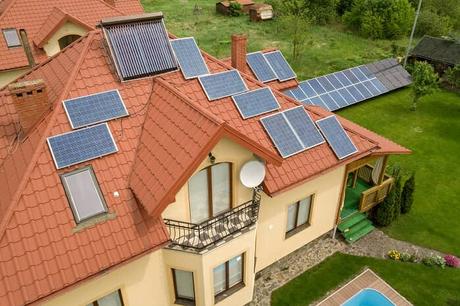 Aerial view of large house with multiple solar panels