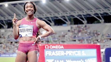 Shelly-Ann Fraser-Pryce (centre)  celebrates her victory     