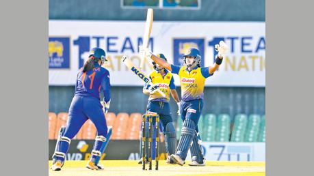 Chamari Atapattu celebrating her fifty while Harshitha Samarawickrama looks on. (Pix curtecy SLC)