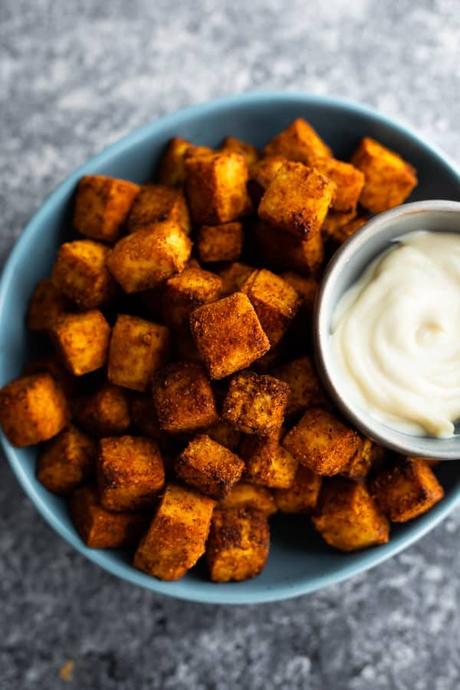 close up shot of air fryer tofu in bowl with dip