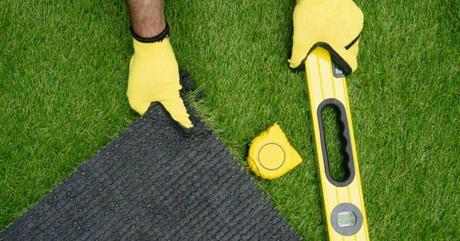 a man measuring sod grass roll