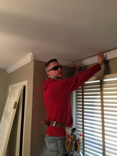 man installing crown molding