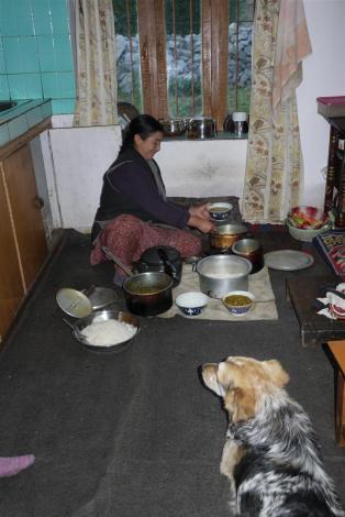 Rumi looks on while Ama Laskit cooks delicious momos, dal and palak paneer.