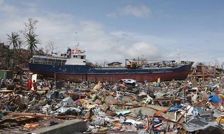 A boat washed ashore sits on destroyed houses in Tacloban. Photograph: Aaron Favila/AP