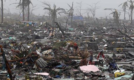 Residents search for belongings in the wreckage of Tacloban. Photograph: Dennis Sabangan/EPA