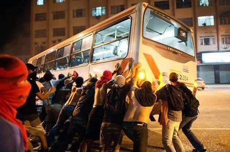 Demonstrators in Niteroi, near Rio de Janeiro, overturn a bus during protests. Clashes with police continued even as bus fare hikes were rolled back in two cities after protests on June 20, 2013.
