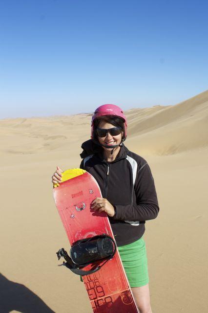 Laurel Robbins posing with her sandboard in Namibia.