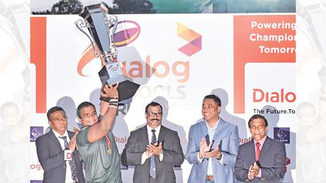 Isipathana skipper, Daham Wickrammarachchi, lifts the coveted Dialog Schools Rugby League Trophy. Also in picture, Nirodha Wijerama, Secretary, SLSRFA, B A Abeyratne, President, SLSRFA,  Harsha Samaranayake, Senior General Manager – Brand and Media, Group Marketing, Dialog Axiata PLC and Upali Amarathunga, Deputy Director, Physical Education, Ministry of Education.