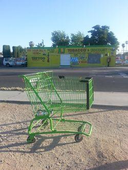 This Shopping Cart is art, indeed. This is a Dollar General Shopping Cart. I like how it looks near this particular tobacco and discount store.