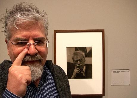 photo of Rick next to photographic portrait of Alfred Stieglitz taken by Paul Strand