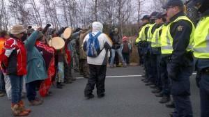 A line of Mi’kmaq and their supporters confront a line of RCMP officers on Hwy 11 Thursday.