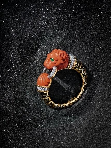David Webb  Carved coral lion cuff with diamonds, black enamel and emeralds. USA. $135,000