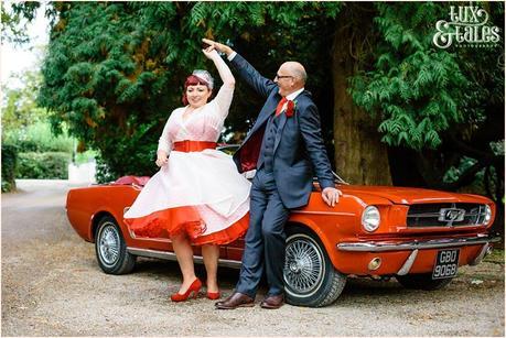 Bride and groom spin in front of red vintage mustang photography