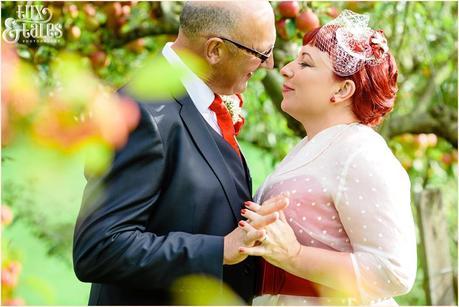 Wedding pose in apple orchard with a vintage bride in yorkshire