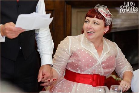 bride holding the hand of groom during speeches at vintage themed wedding in yorkshire 