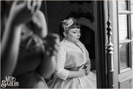 Bride in mirror at vintage themed weddign couture company wedding dress 