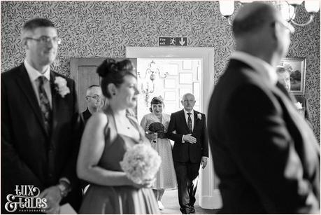 Vintage themed bride walks up aisle in yorkshire wedding 