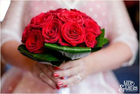red rose bouquet bride with red sparkle nail polish 