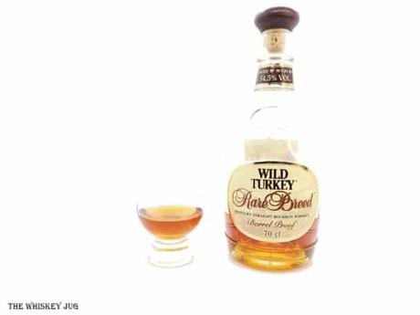 White background tasting shot with the Wild Turkey Rare Breed W-T-01-95 bottle and a glass of whiskey next to it.