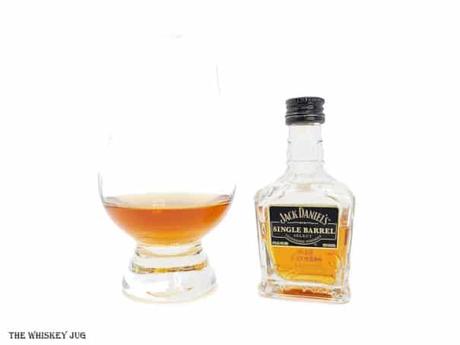 White background tasting shot with the Jack Daniel's Single Barrel Select bottle and a glass of whiskey next to it.