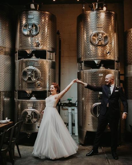 best wedding venues in new york newlyweds holding hands near barrels