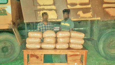 The suspects with the Kerala cannabis and the lorry in which it was transported. 