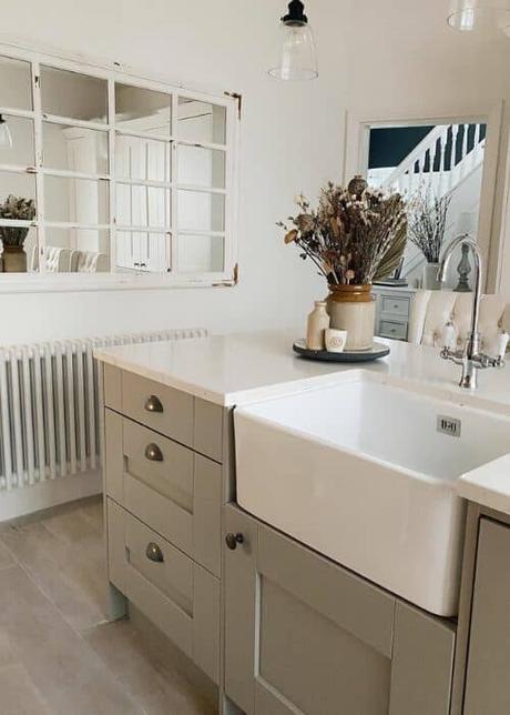 small white column radiator in a beige kitchen