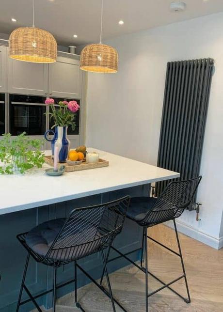 vertical anthracite column radiator in a kitchen