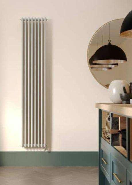 white vertical electric radiator in a kitchen