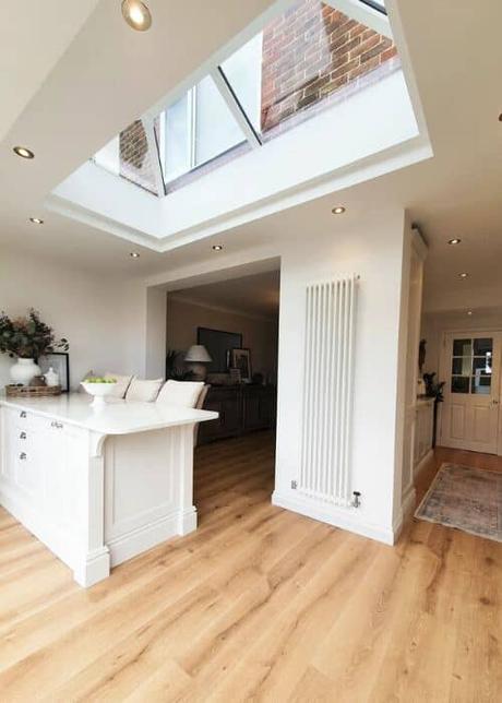 white column radiator in a white kitchen