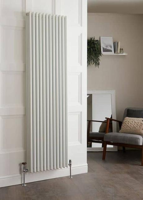 vertical white column aluminum radiator in a kitchen