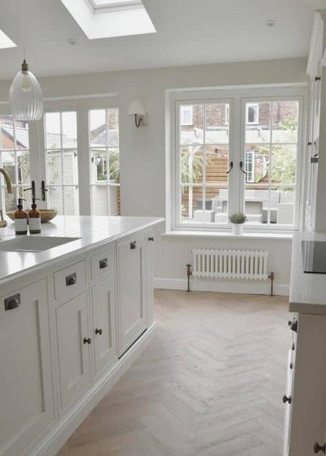 small low level white column radiator in a kitchen